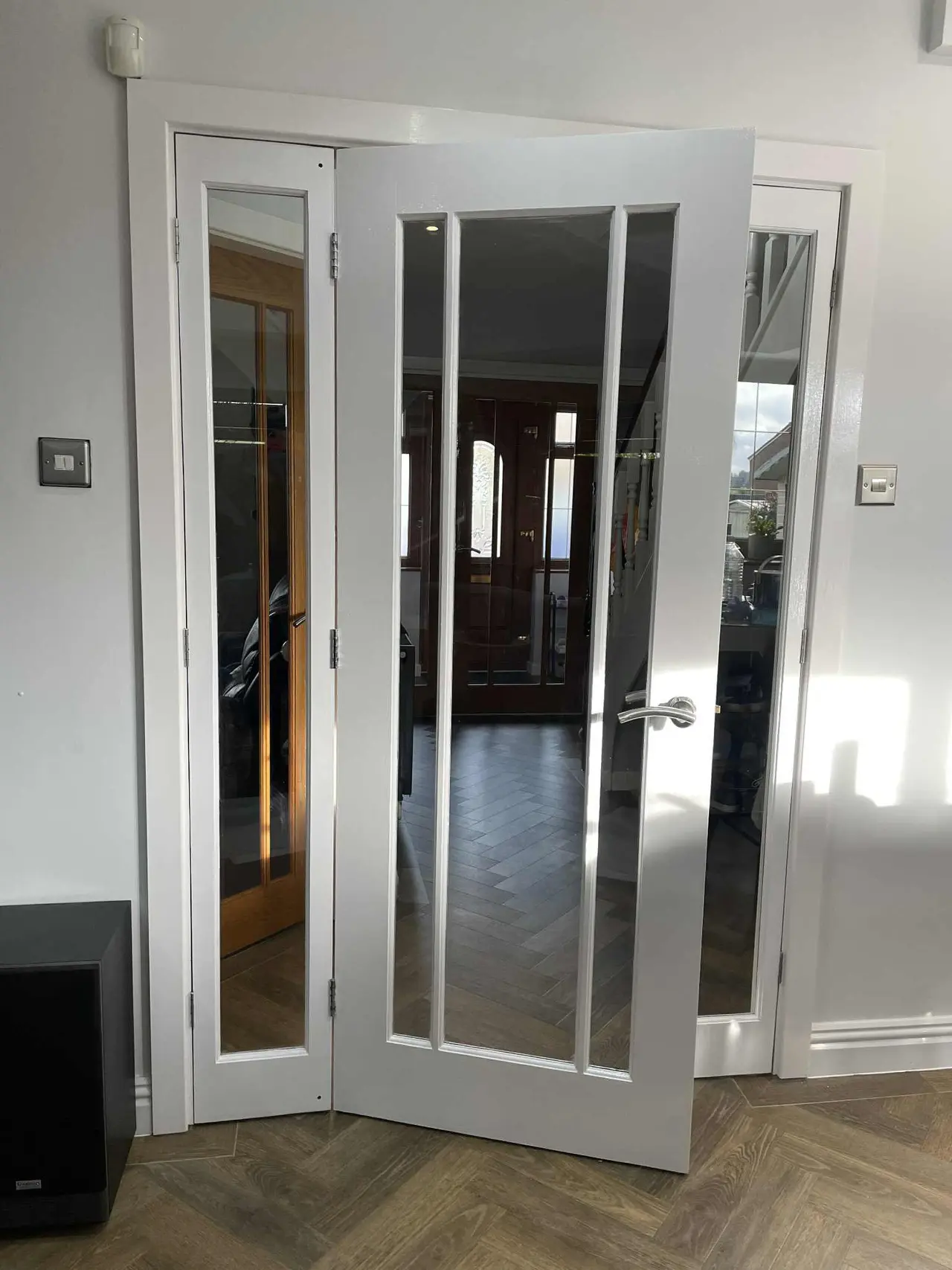 White bi-fold door installation with glass panels