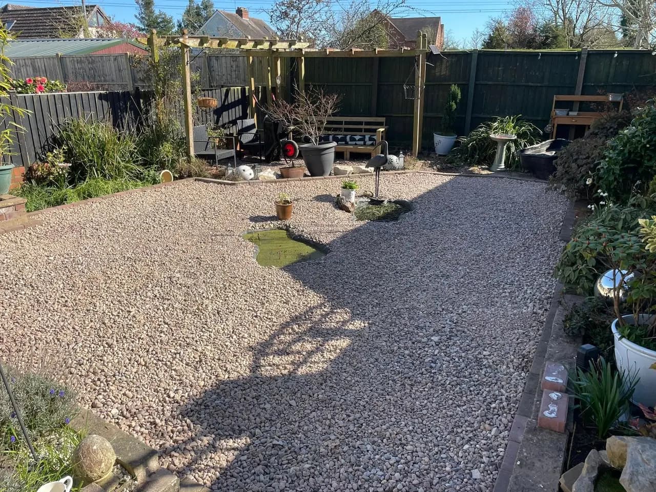 Complete garden transformation with gravel paths and pergola