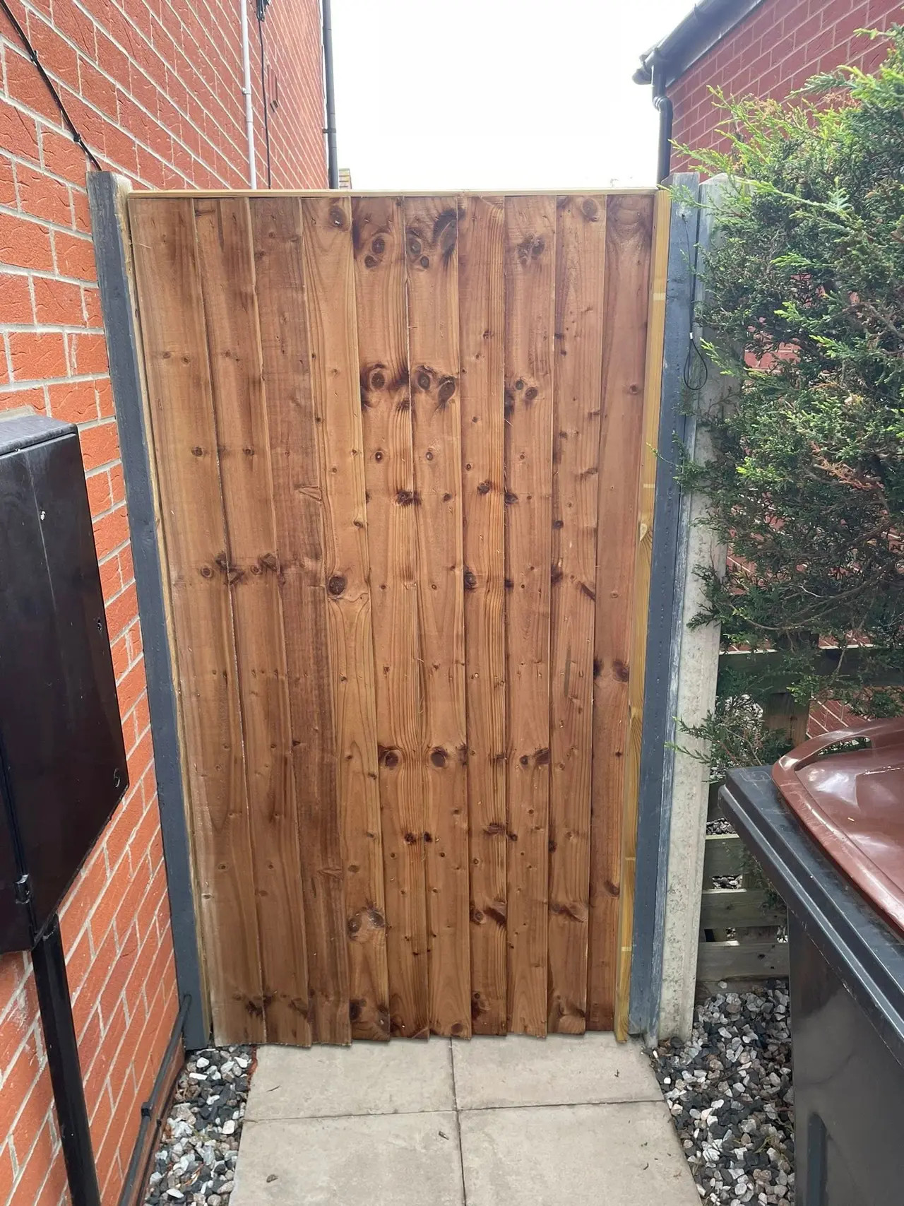 New timber gate fitted between house walls