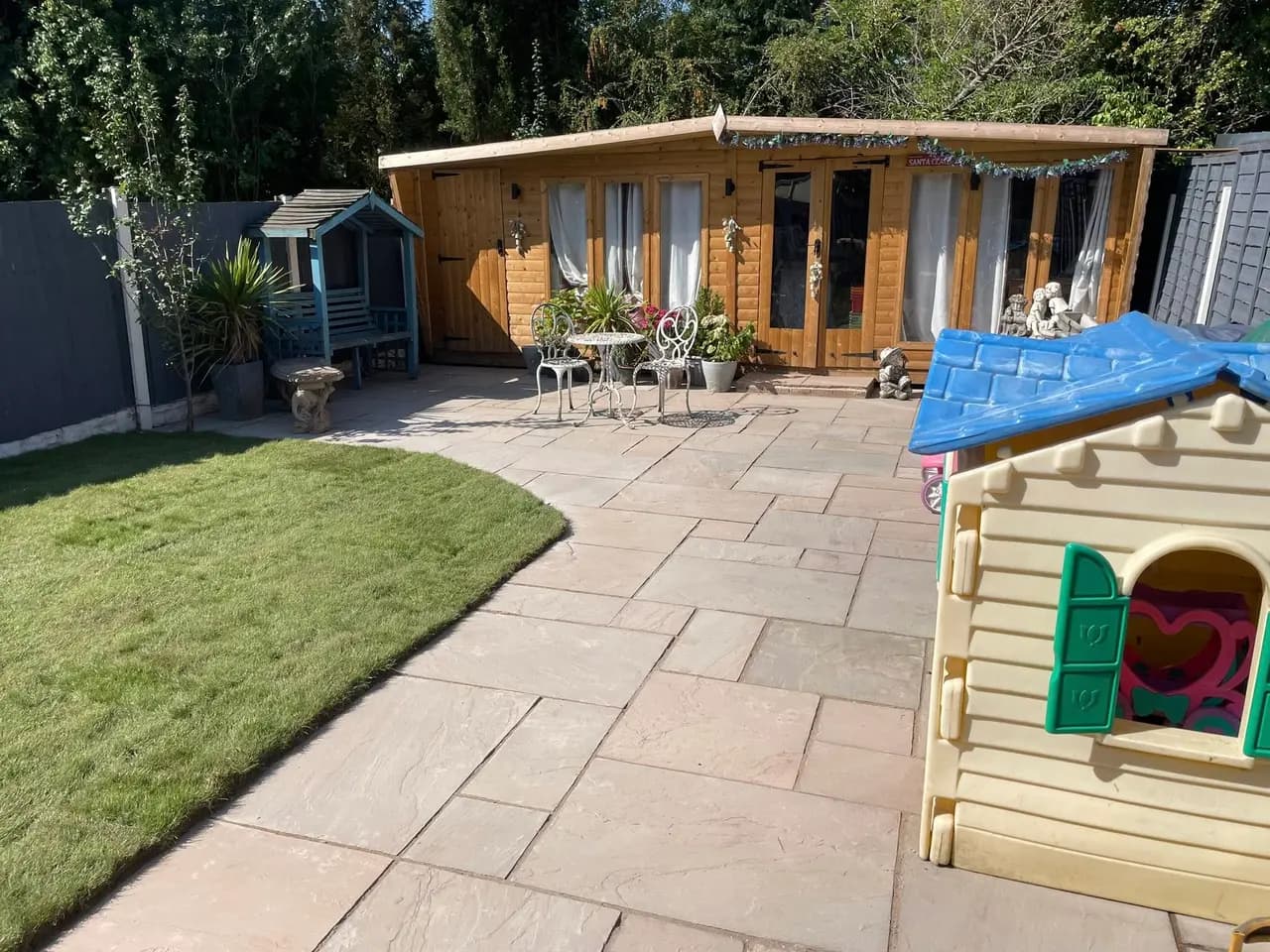 Summerhouse and patio installation with neat lawn